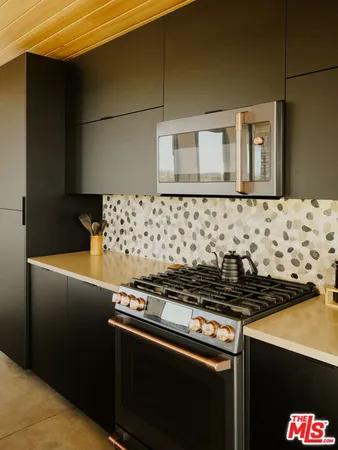 a stove top oven sitting inside of a kitchen