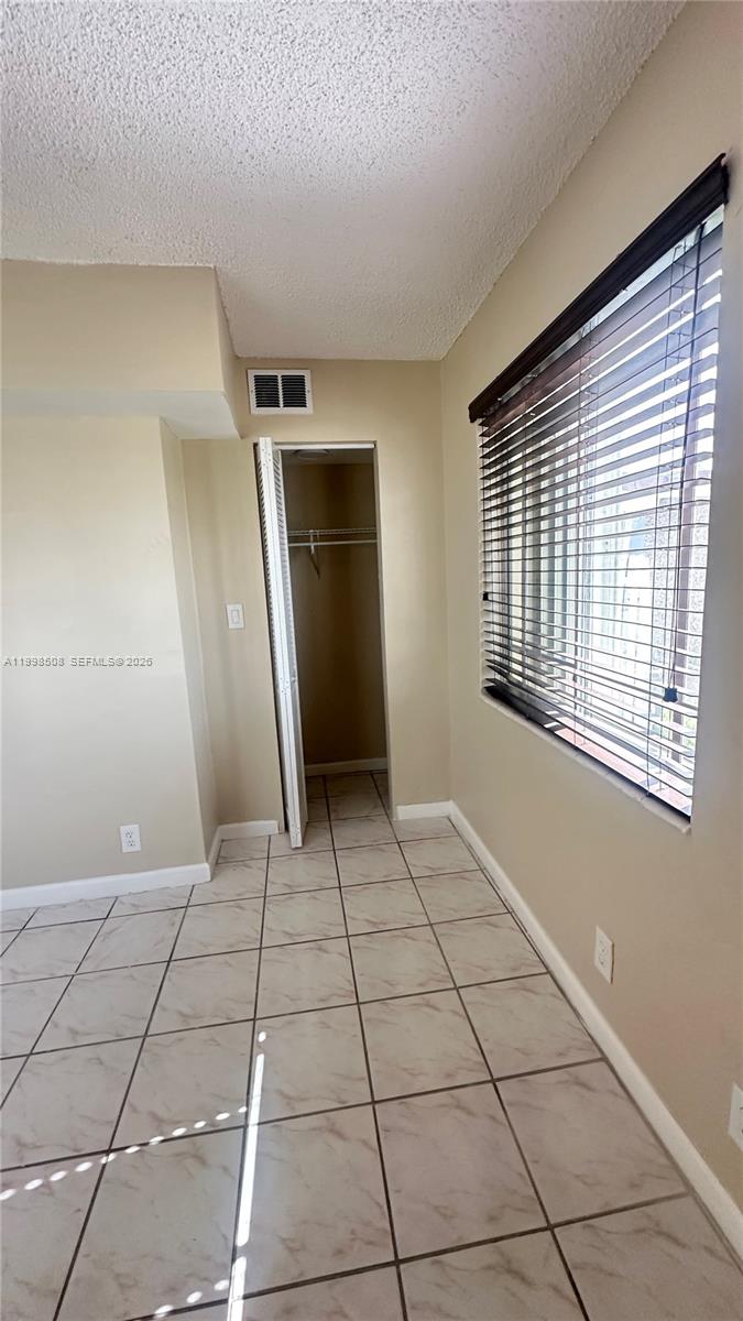 990 East 2nd Street, Unit B Hialeah, FL 33010 - Photo 11 of 12 a view of a livingroom with an empty space and a window