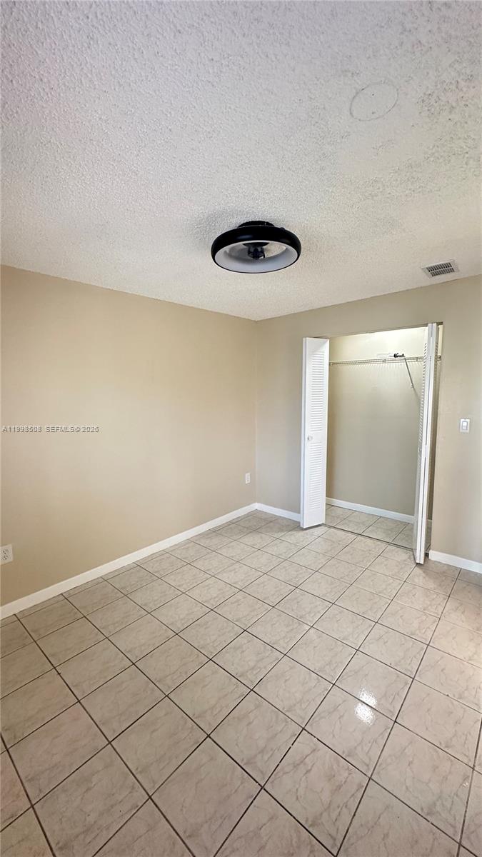 990 East 2nd Street, Unit B Hialeah, FL 33010 - Photo 12 of 12 a view of an empty room and wooden floor