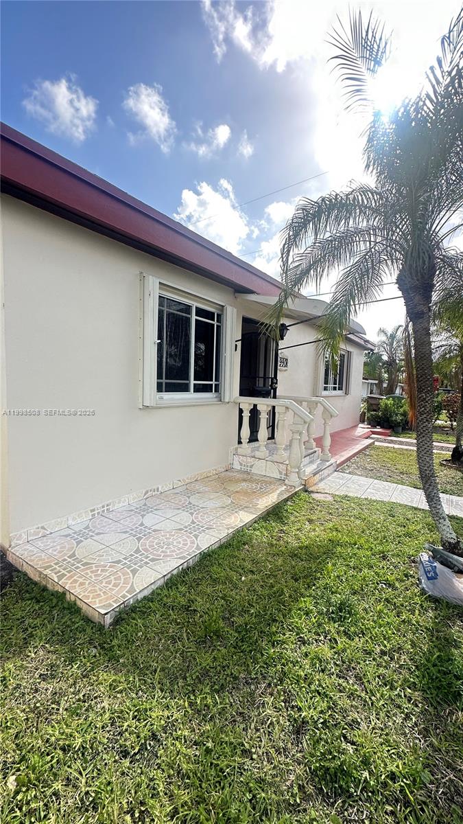 990 East 2nd Street, Unit B Hialeah, FL 33010 - Photo 3 of 12 a backyard of a house with table and chairs