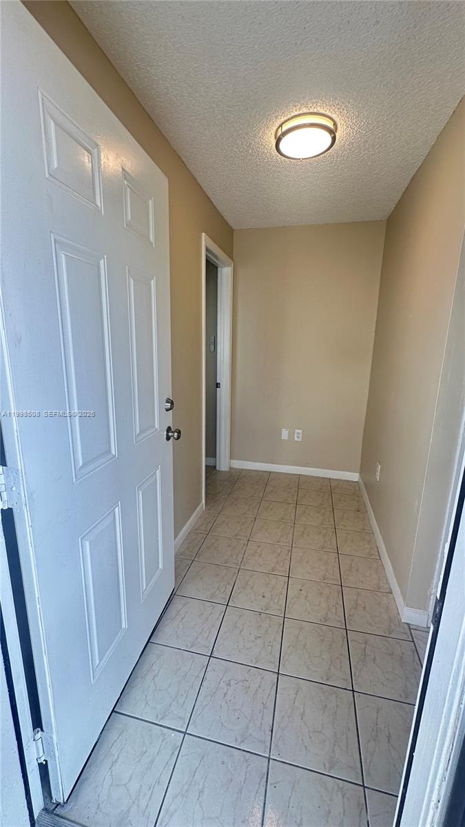 990 East 2nd Street, Unit B Hialeah, FL 33010 - Photo 4 of 12 a view of a livingroom with an empty space and a window