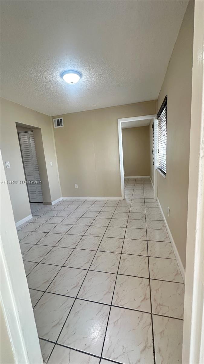 990 East 2nd Street, Unit B Hialeah, FL 33010 - Photo 7 of 12 a view of an empty room and window
