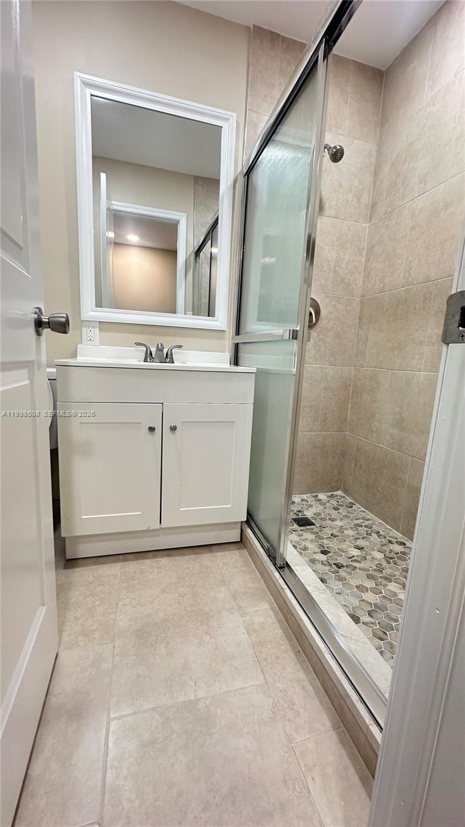 990 East 2nd Street, Unit B Hialeah, FL 33010 - Photo 8 of 12 a bathroom with a sink and a mirror