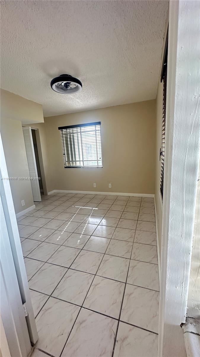 990 East 2nd Street, Unit B Hialeah, FL 33010 - Photo 10 of 12 a view of an empty room and window