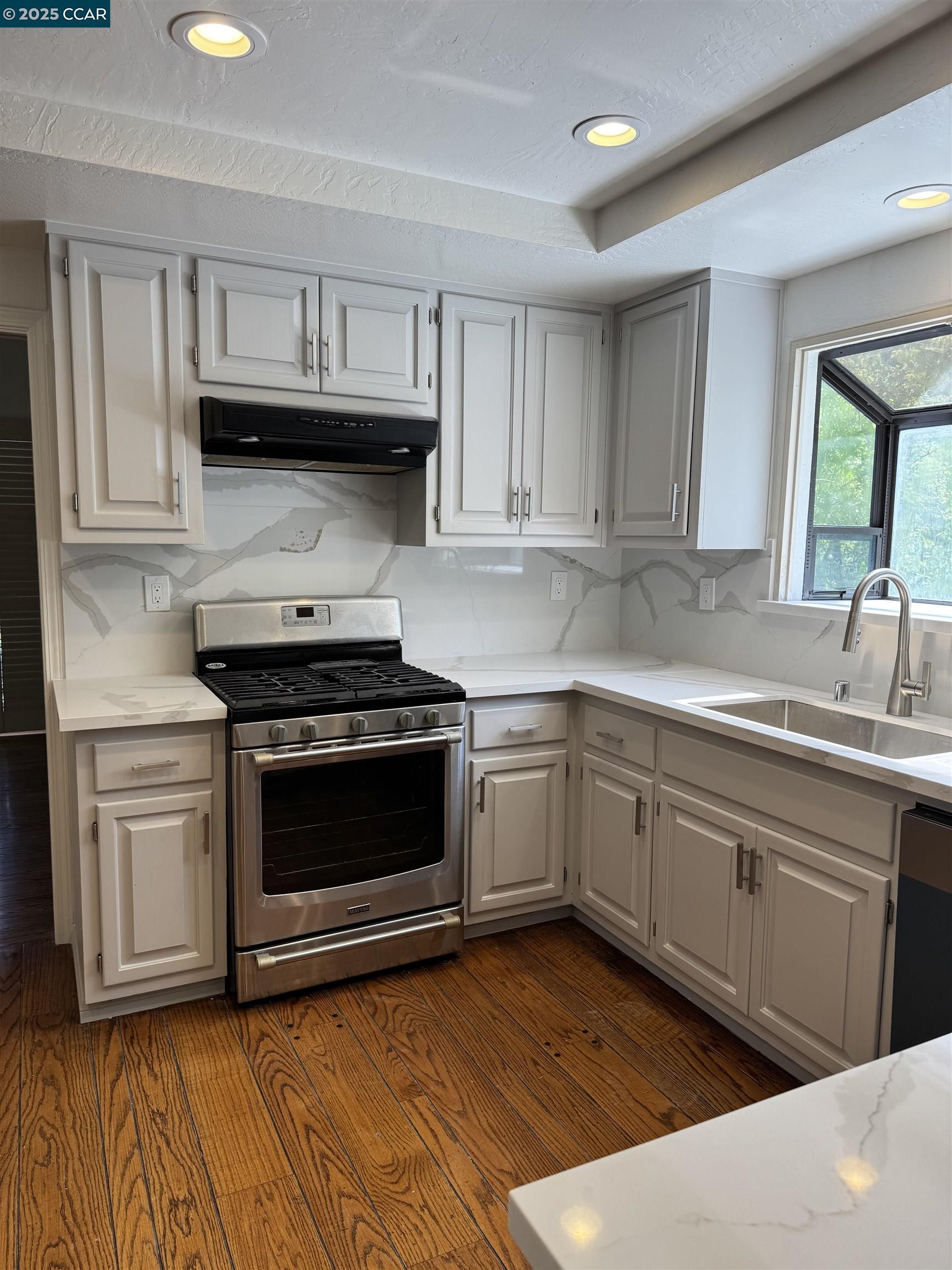 20 Tamarisk Moraga, CA 94556 - Photo 5 of 18 a kitchen with stainless steel appliances granite countertop a stove a sink and a microwave