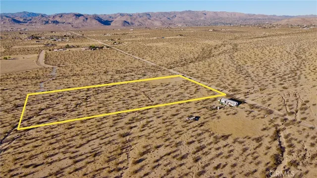 a view of a dry yard with mountain