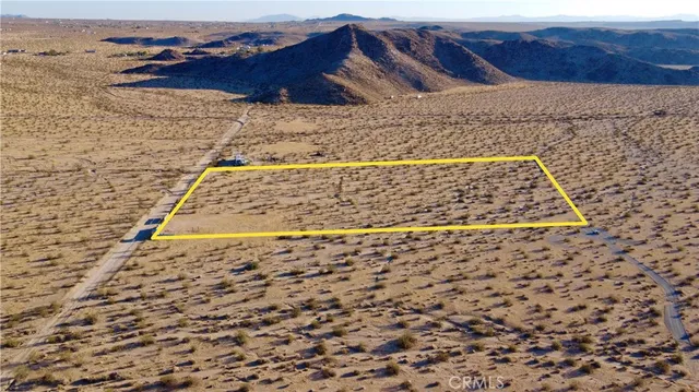 a view of an ocean beach and mountain