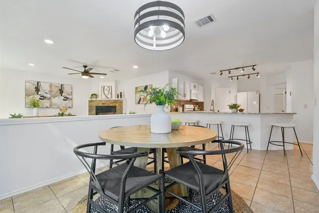 a view of a dining room with furniture and chandelier