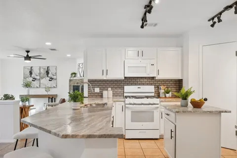 a kitchen with a sink and white cabinets