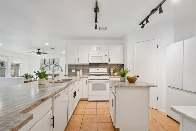 a bathroom with a granite countertop sink a mirror and vanity