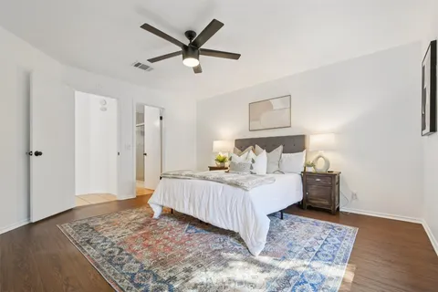 a bedroom with a bed dresser and a window