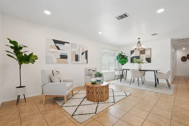 a living room with furniture and a potted plant