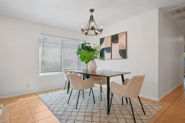 a view of a dining room with furniture and chandelier