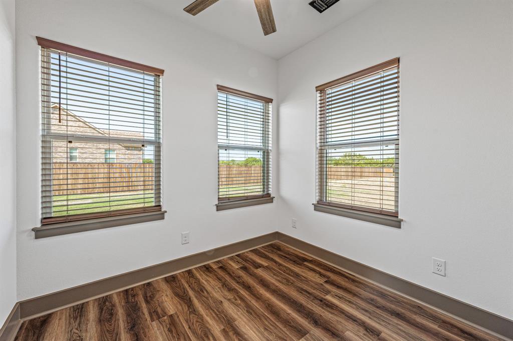 1035 Barton Ranch Road Nemo, TX 76070 - Photo 12 of 28 Unfurnished room featuring dark wood-style floors and a ceiling fan