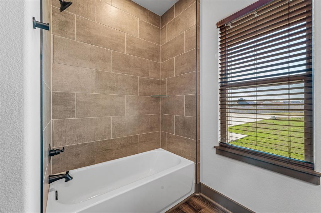 1035 Barton Ranch Road Nemo, TX 76070 - Photo 15 of 28 Bathroom with bathtub / shower combination, plenty of natural light, and dark wood-type flooring