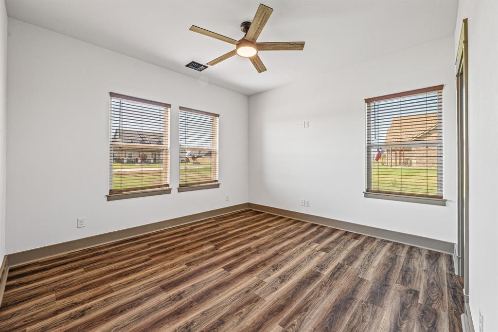 1035 Barton Ranch Road Nemo, TX 76070 - Photo 16 of 28 Empty room featuring dark wood-style flooring and a ceiling fan