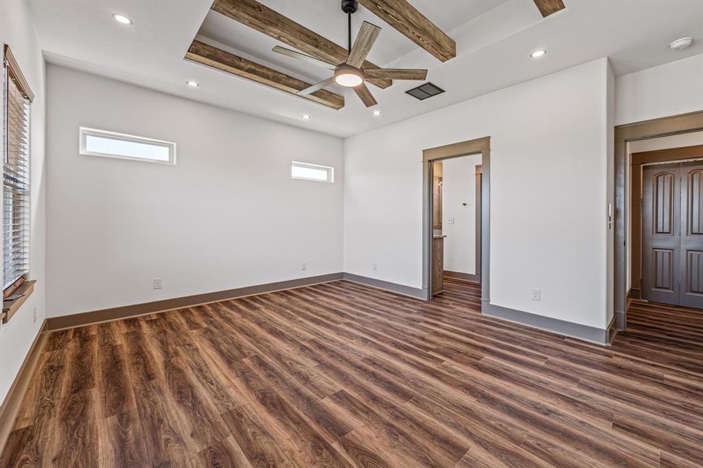 1035 Barton Ranch Road Nemo, TX 76070 - Photo 20 of 28 Unfurnished bedroom featuring beam ceiling, dark wood finished floors, recessed lighting, ceiling fan, and connected bathroom