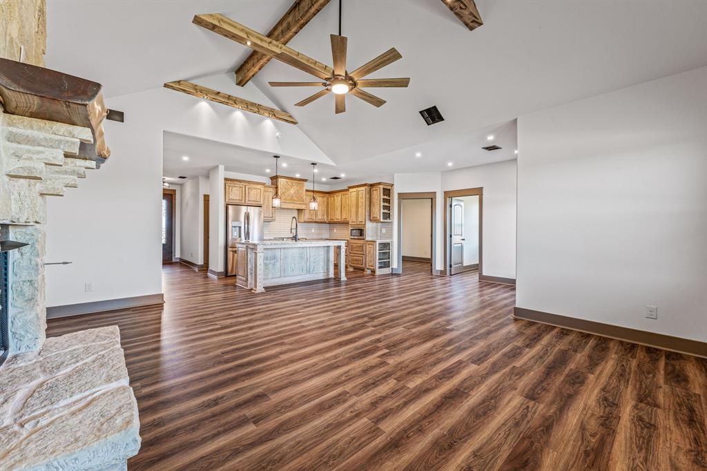 1035 Barton Ranch Road Nemo, TX 76070 - Photo 2 of 28 Unfurnished living room featuring beamed ceiling, dark wood finished floors, high vaulted ceiling, a ceiling fan, and recessed lighting
