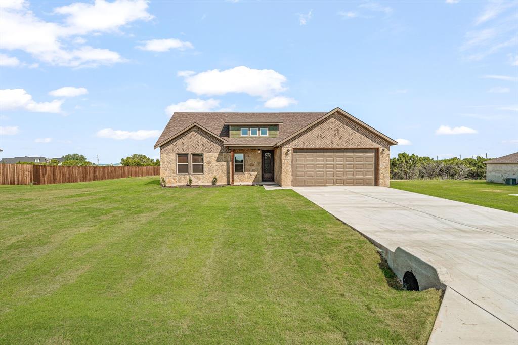 1035 Barton Ranch Road Nemo, TX 76070 - Photo 26 of 28 View of front of property with a front lawn, concrete driveway, a shingled roof, and brick siding