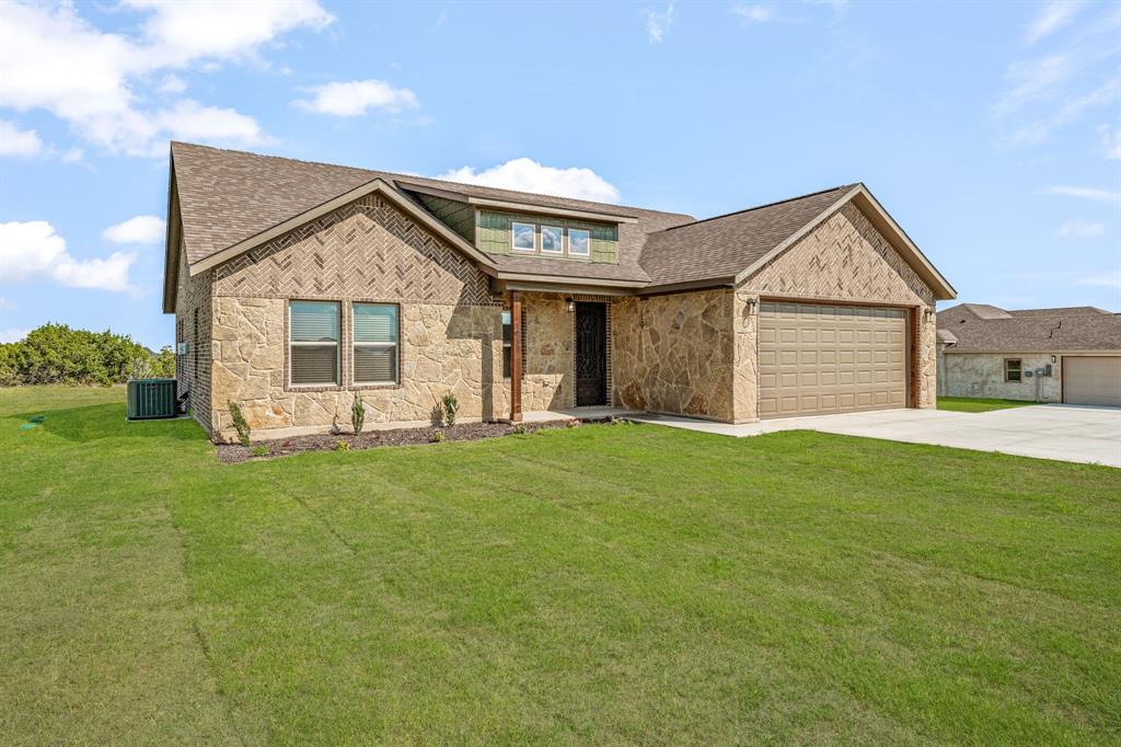 1035 Barton Ranch Road Nemo, TX 76070 - Photo 27 of 28 View of front facade with roof with shingles, a front lawn, driveway, and stone siding