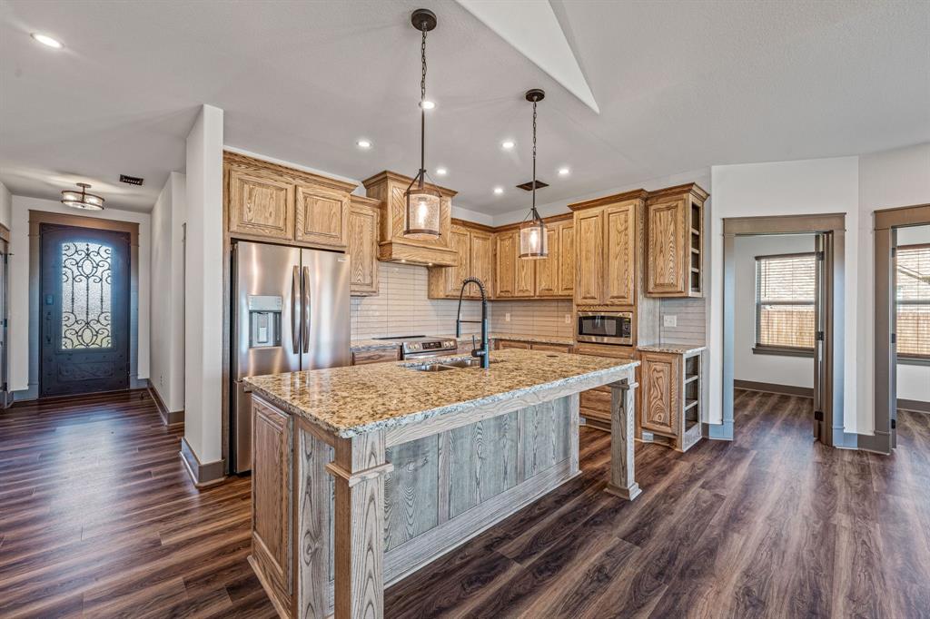 1035 Barton Ranch Road Nemo, TX 76070 - Photo 3 of 28 a kitchen with stainless steel appliances granite countertop a stove and refrigerator