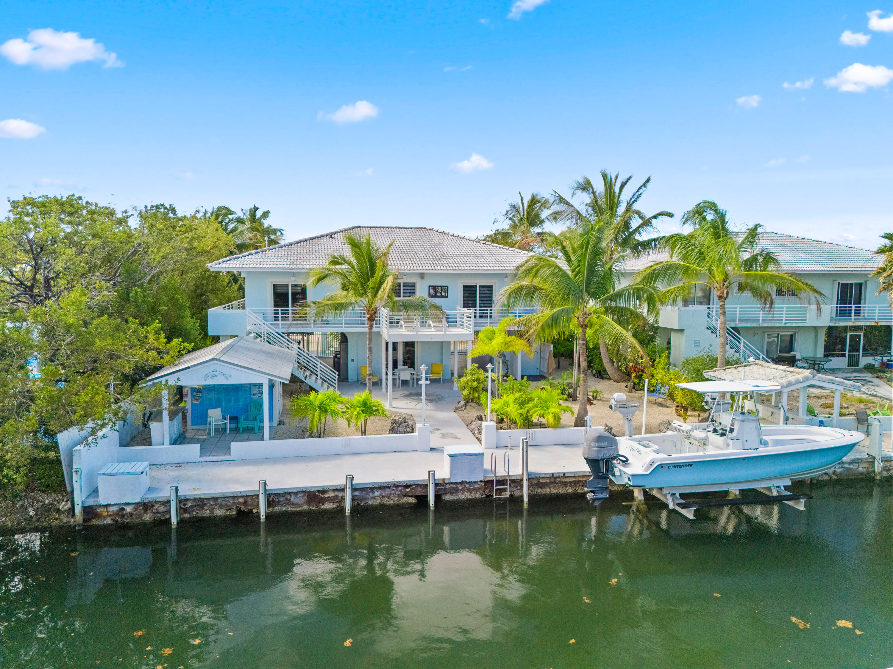 130 Lorelane Place Key Largo, FL 33037 - Photo 1 of 67 a swimming pool with outdoor seating and yard