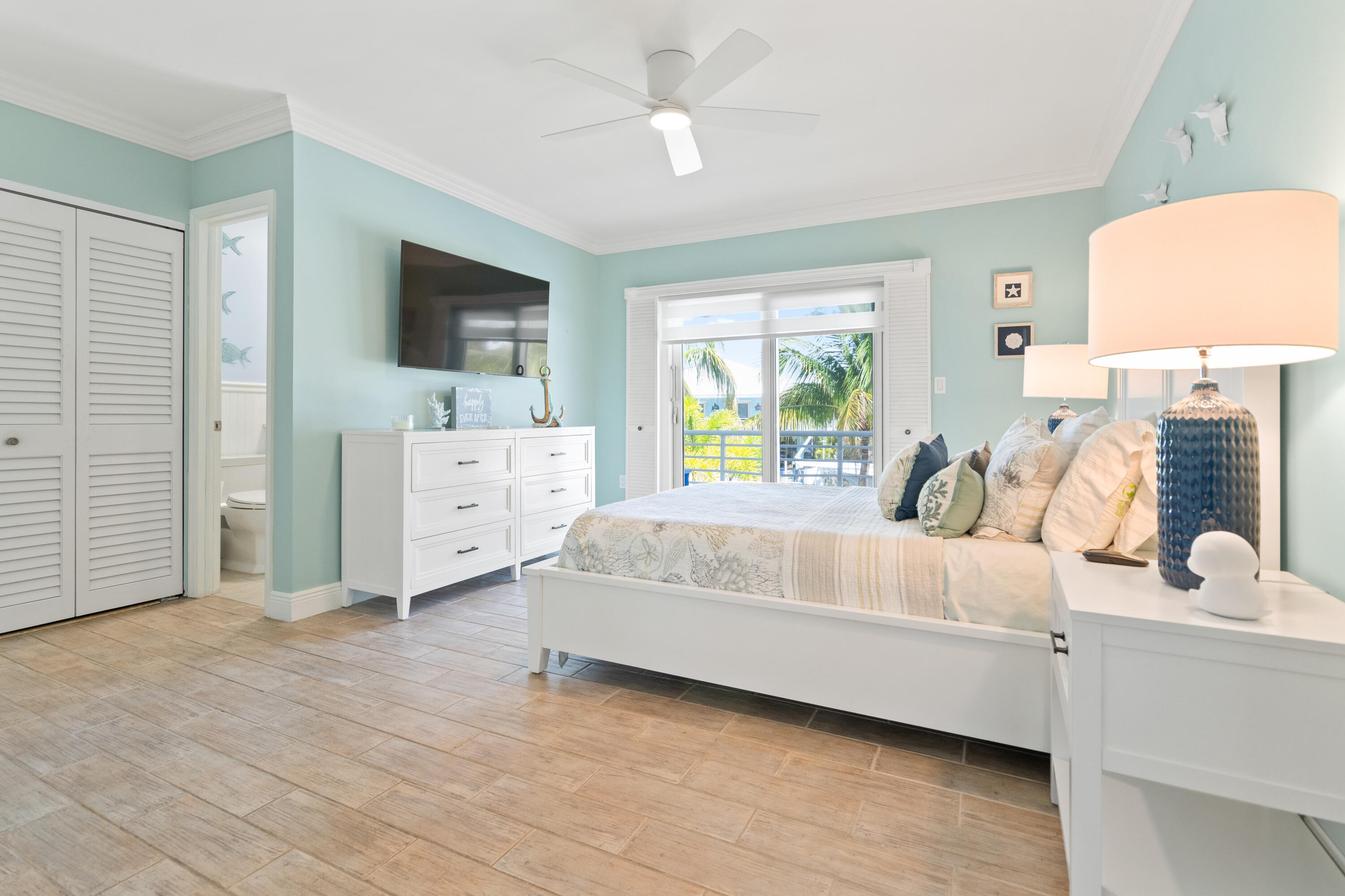 130 Lorelane Place Key Largo, FL 33037 - Photo 16 of 67 a bedroom with a bed and a flat tv screen on dresser