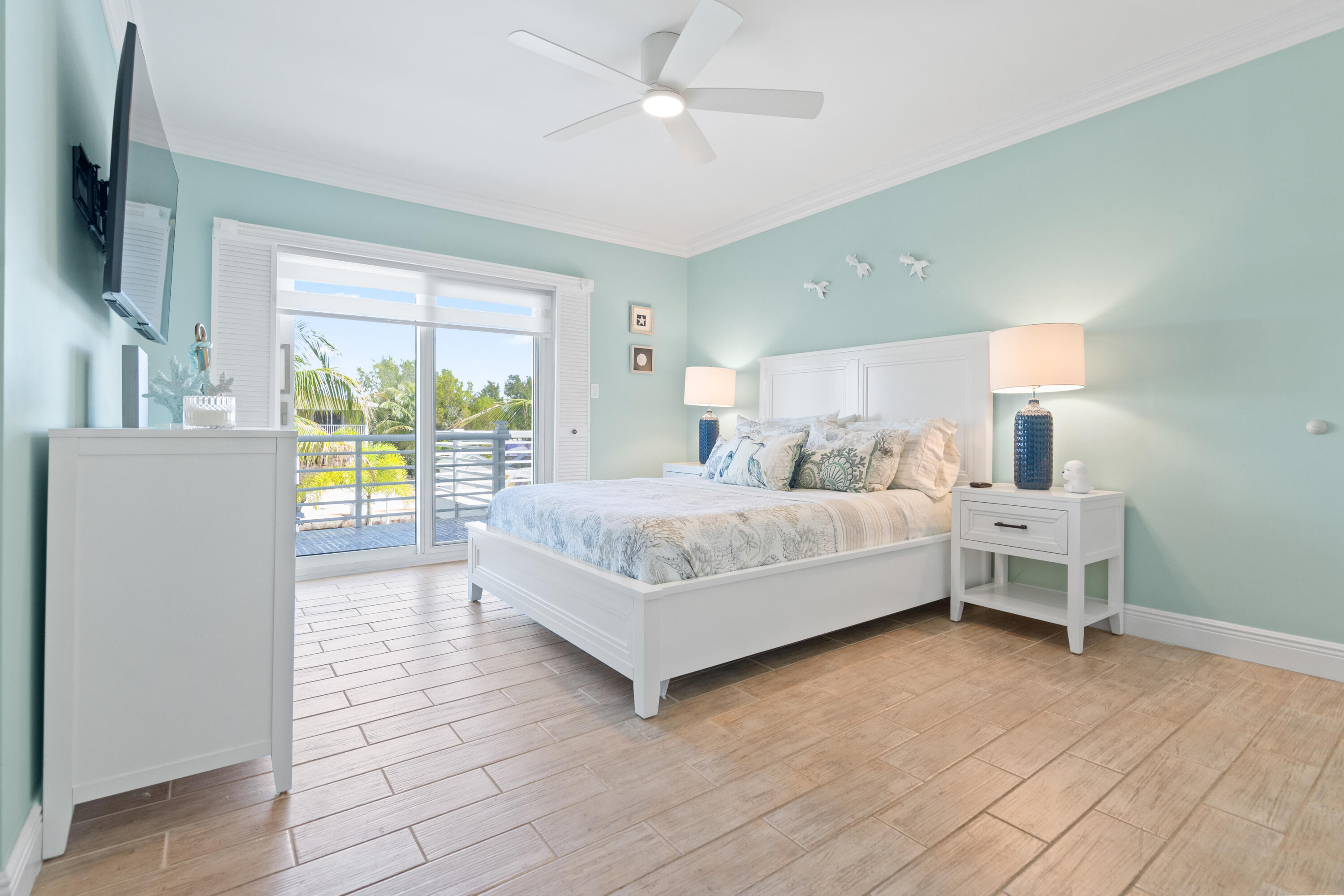 130 Lorelane Place Key Largo, FL 33037 - Photo 17 of 67 a bedroom with a large bed and a chandelier