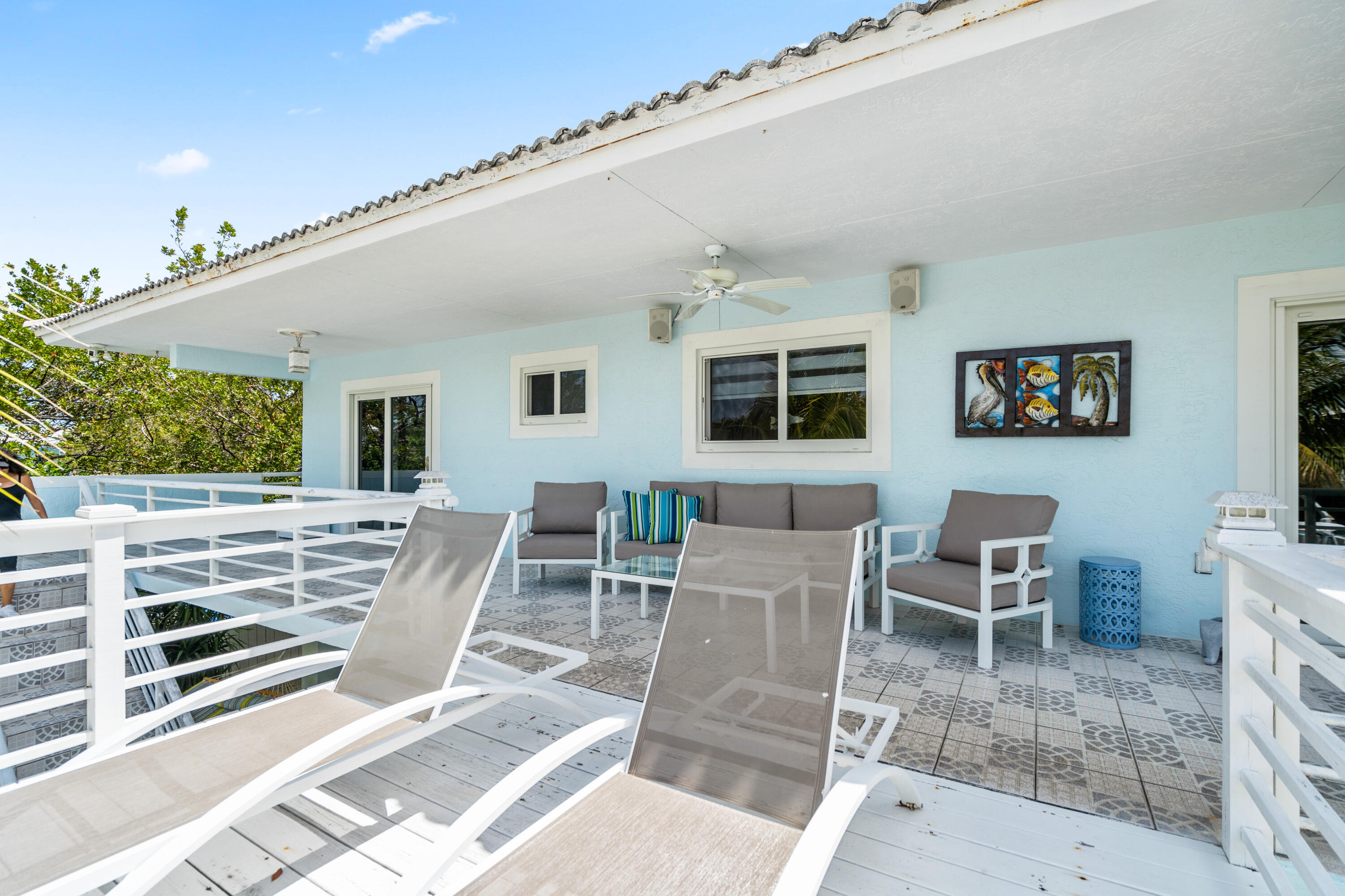 130 Lorelane Place Key Largo, FL 33037 - Photo 28 of 67 a view of a patio with table and chairs with wooden floor and fence