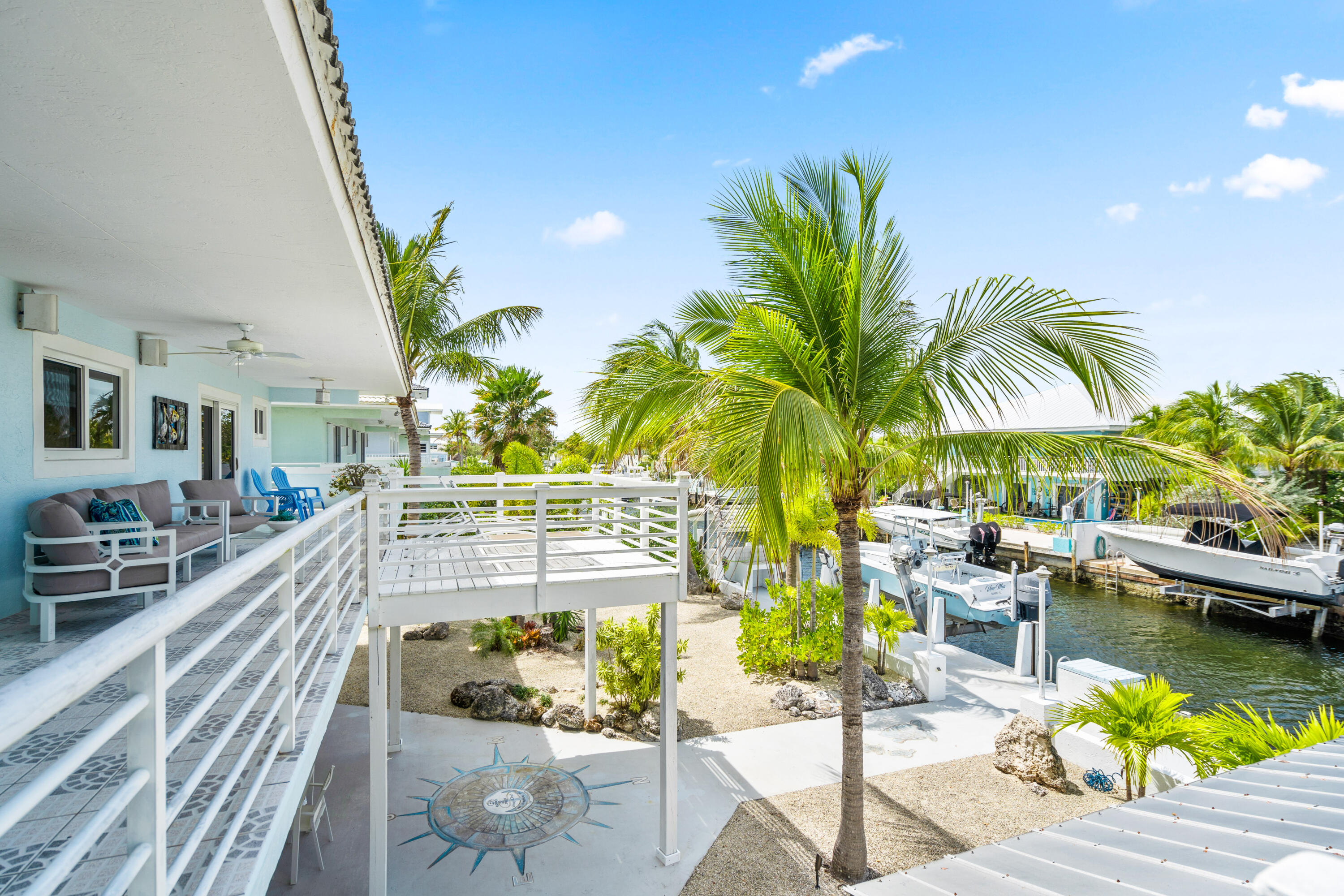 130 Lorelane Place Key Largo, FL 33037 - Photo 4 of 67 a view of a swimming pool with a patio and plants