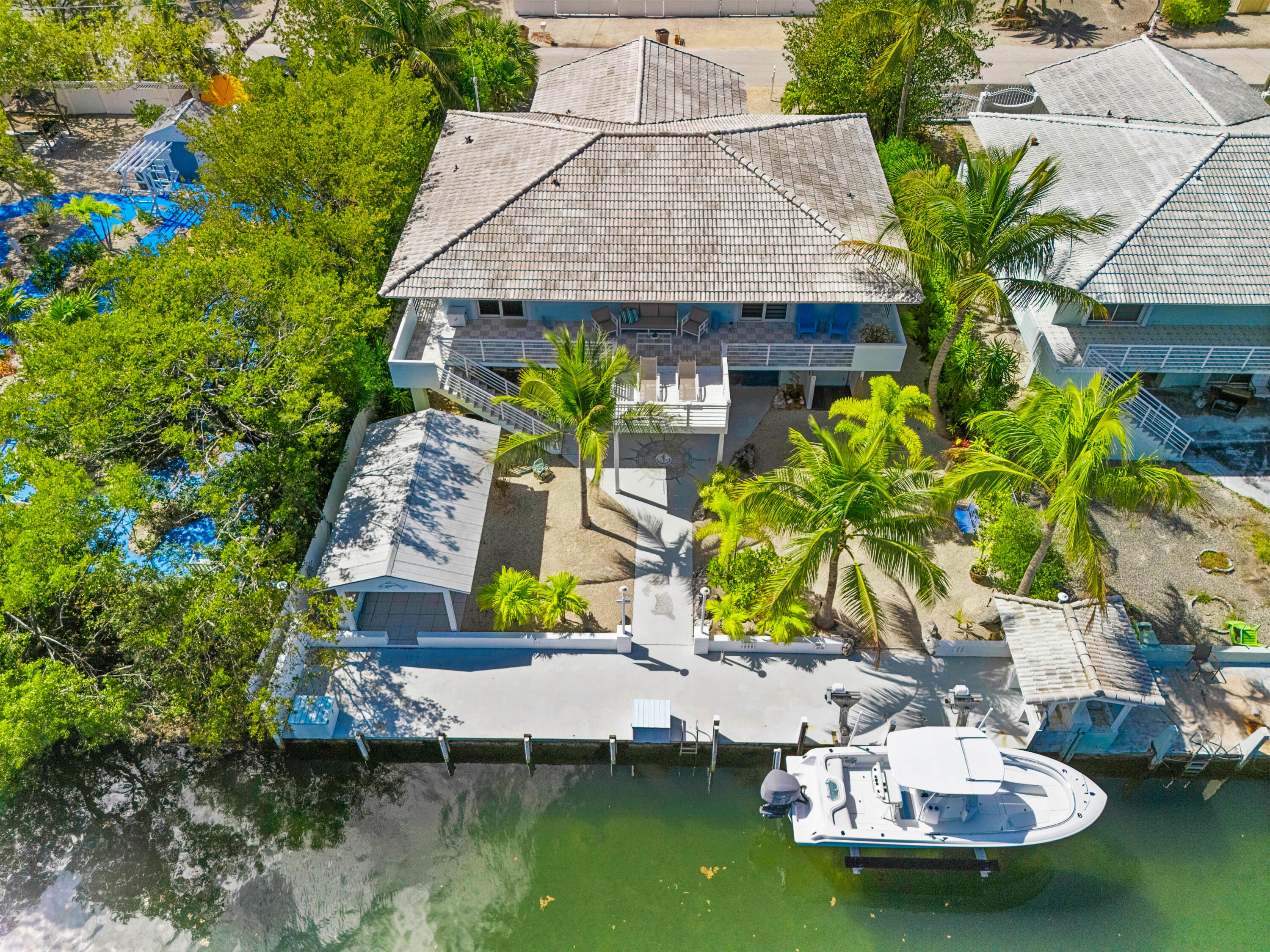 130 Lorelane Place Key Largo, FL 33037 - Photo 5 of 67 a aerial view of a house with swimming pool and outdoor seating
