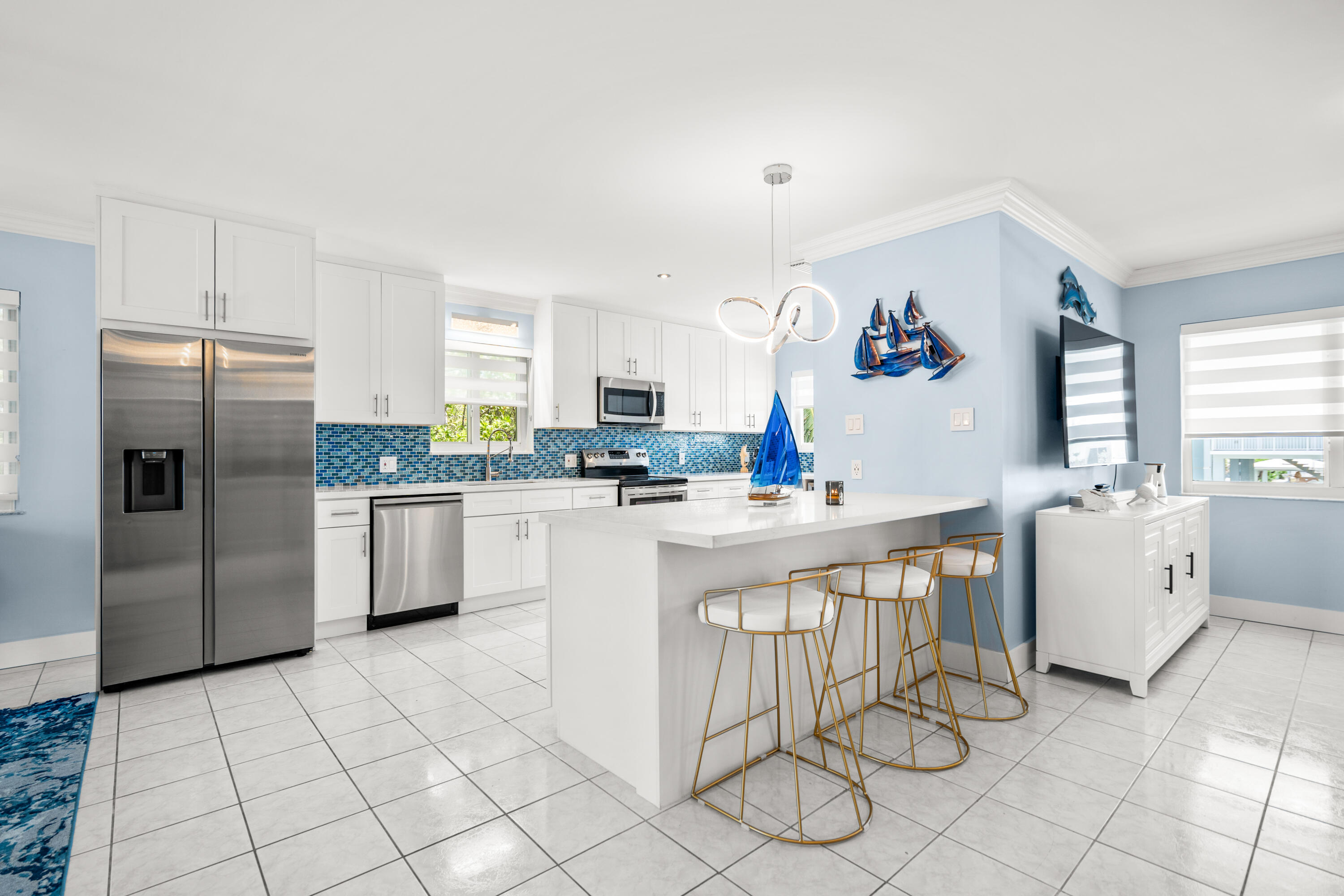 130 Lorelane Place Key Largo, FL 33037 - Photo 8 of 67 a kitchen with white cabinets a table and chairs