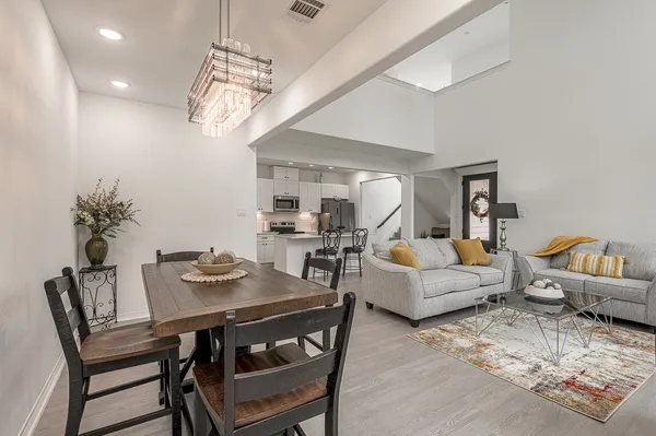 a living room with furniture and view of kitchen
