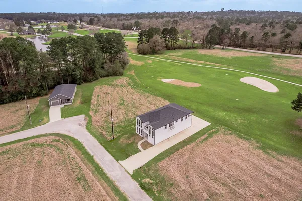 a view of an entryway with wooden floor and a livingroom