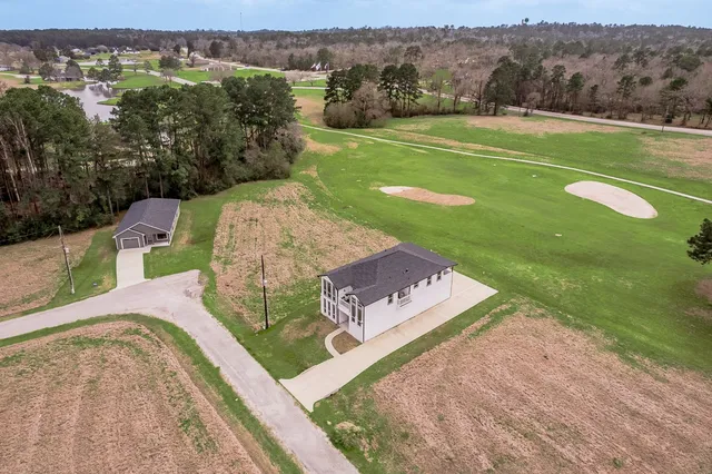 a view of an entryway with wooden floor and a livingroom