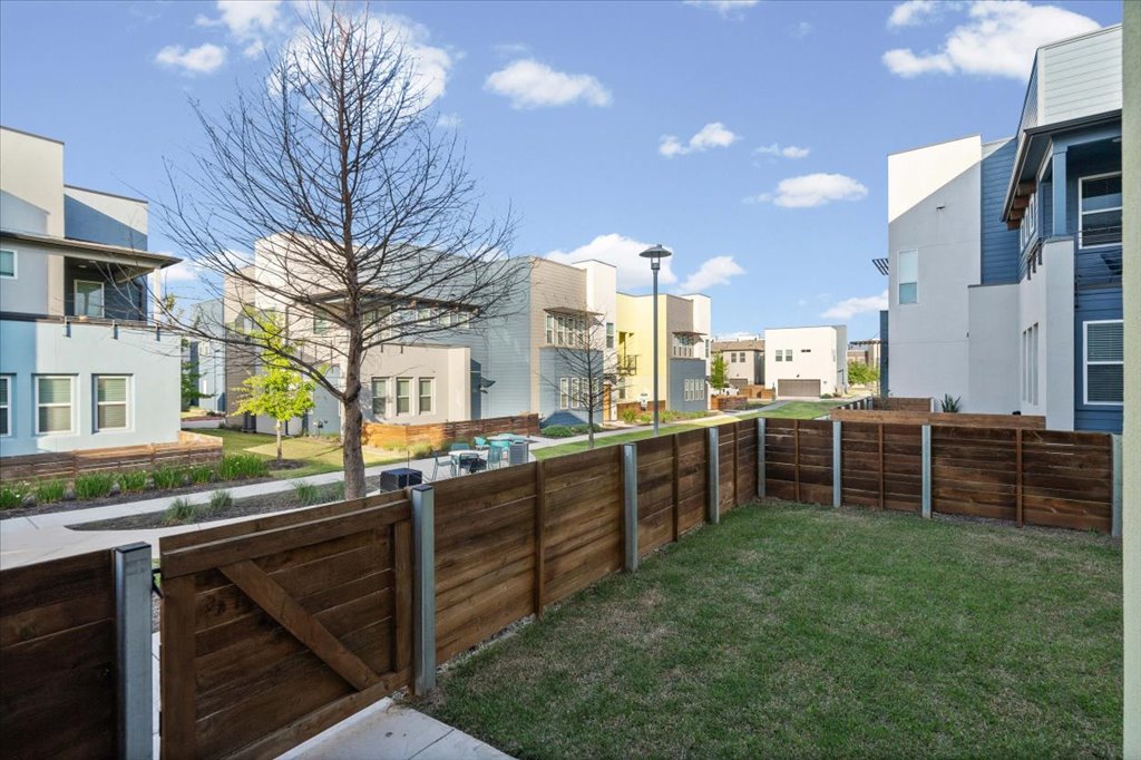 9015 Cattle Baron Path, Unit 705 Austin, TX 78747 - Photo 6 of 35 a view of a house with a backyard and a chair