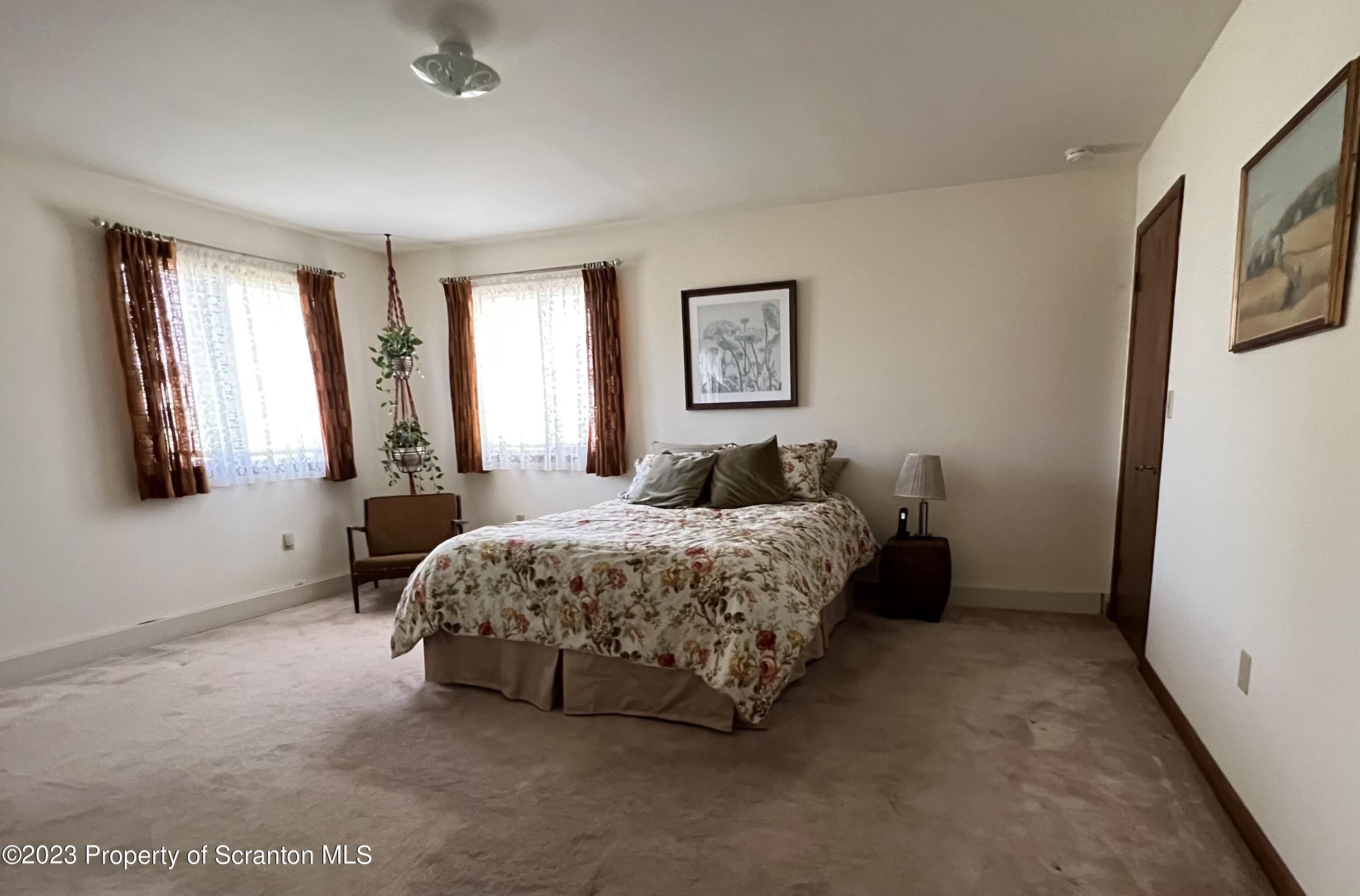4935 Highway 3001 Meshoppen, PA 18630 - Photo 11 of 31 a bedroom with a bed lamp and window