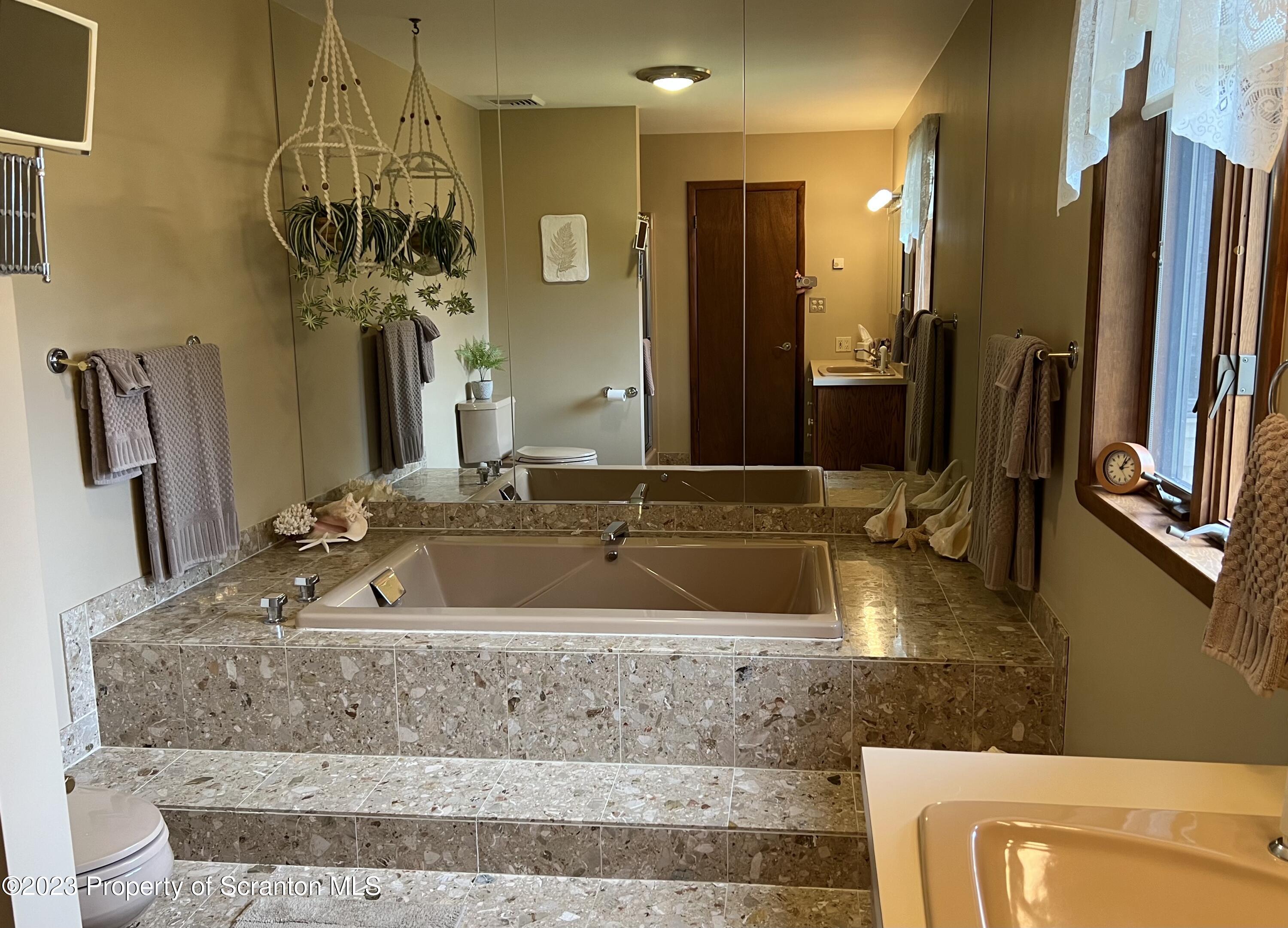 4935 Highway 3001 Meshoppen, PA 18630 - Photo 12 of 31 a bathroom with sink a bathtub and a mirror
