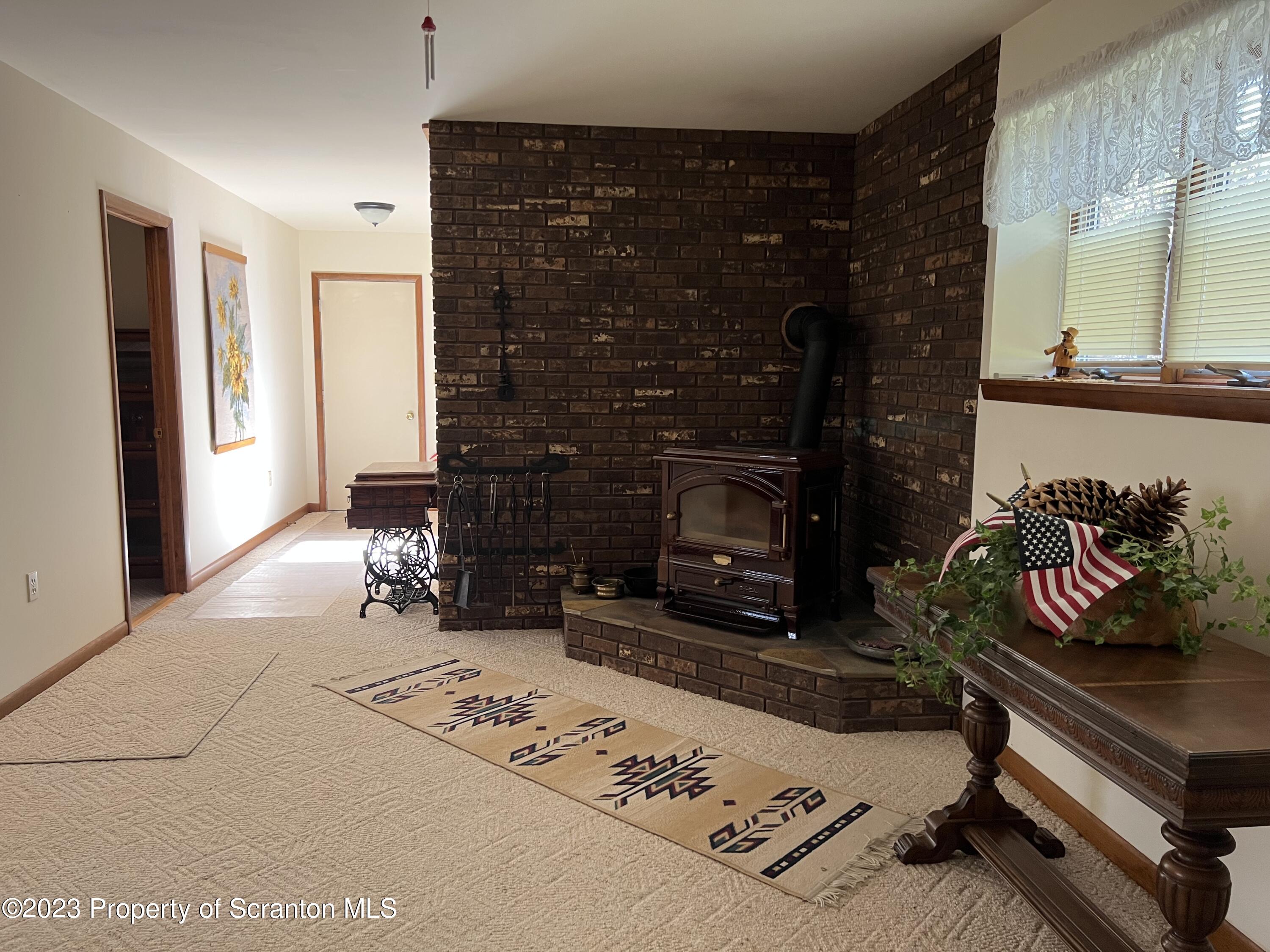 4935 Highway 3001 Meshoppen, PA 18630 - Photo 18 of 31 a living room with furniture a rug and a fireplace