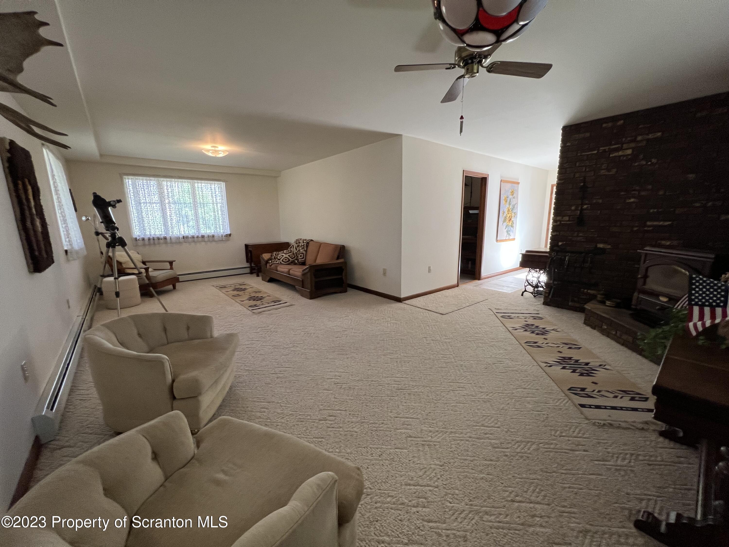 4935 Highway 3001 Meshoppen, PA 18630 - Photo 19 of 31 a living room with furniture a flat screen tv and a fireplace