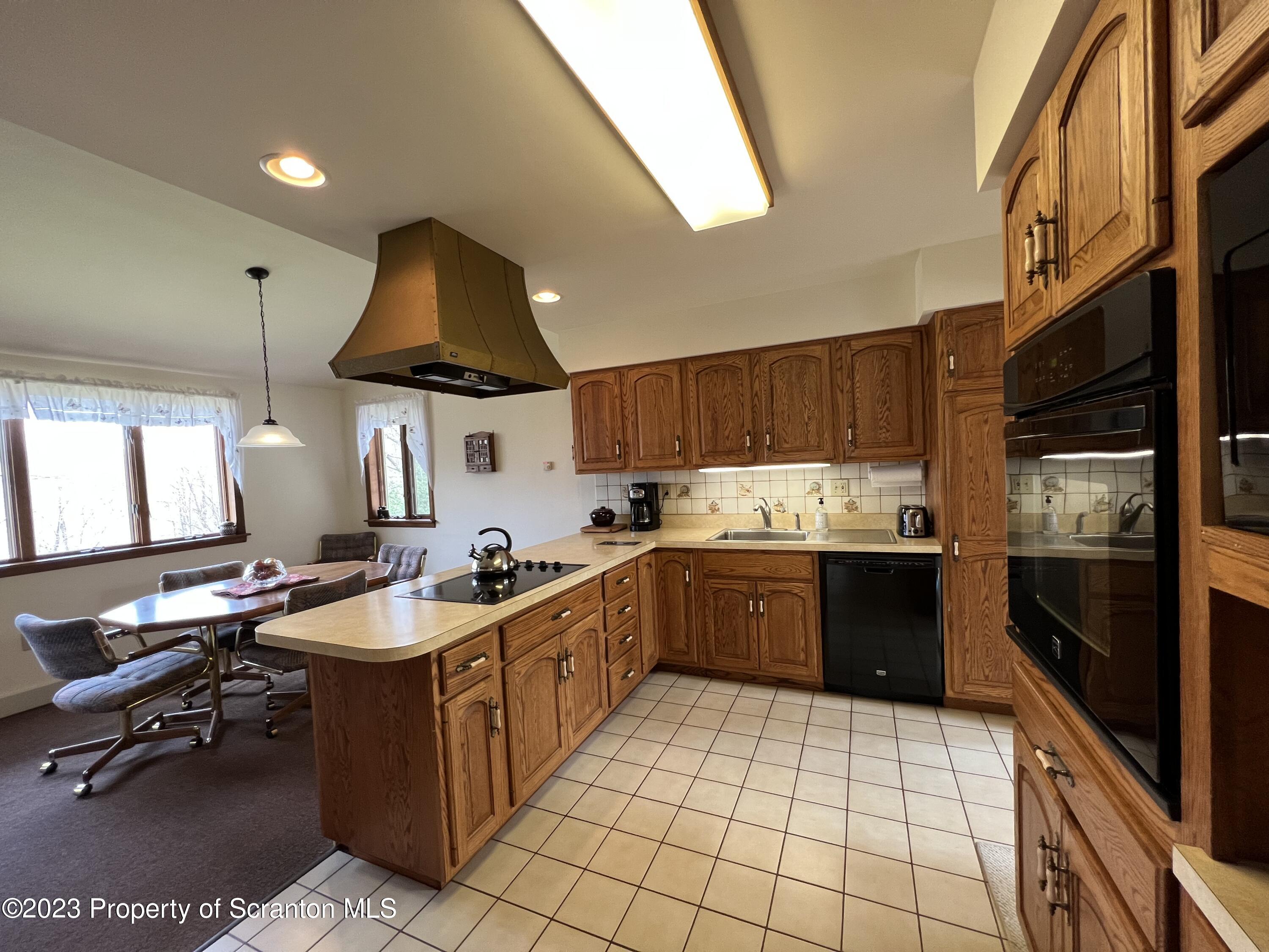 4935 Highway 3001 Meshoppen, PA 18630 - Photo 8 of 31 a kitchen with a sink a stove and a refrigerator