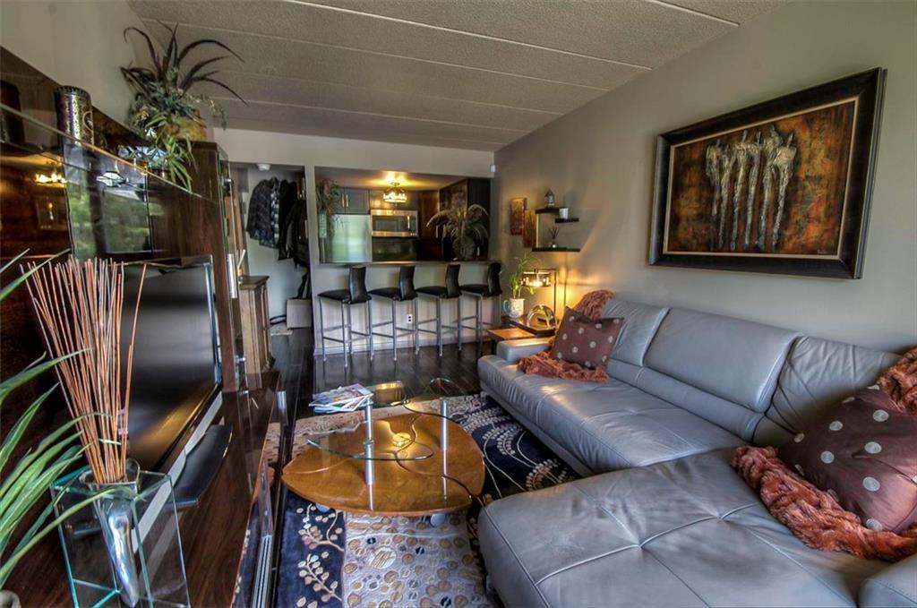 9995 Shore Road, Unit 18C Brooklyn, NY 11209 - Photo 4 of 15 a living room with furniture and a floor to ceiling window