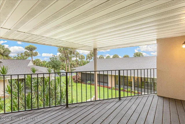 a view of balcony with wooden floor