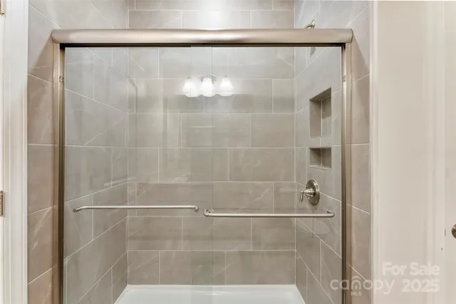 a bathroom with a glass shower door