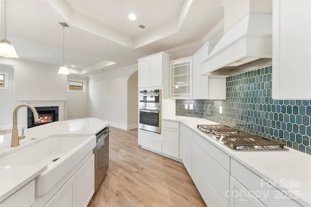 a kitchen with sink stove and refrigerator