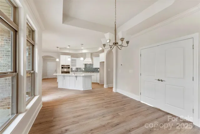 a view of kitchen with refrigerator and window