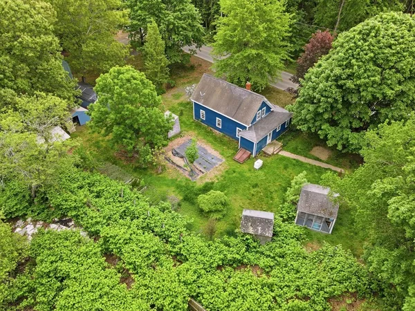 an aerial view of a house with a yard