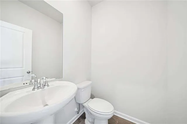 a bathroom with a sink a toilet and mirror