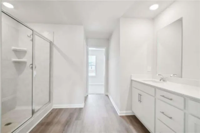 a view of bathroom with a sink mirror and shower