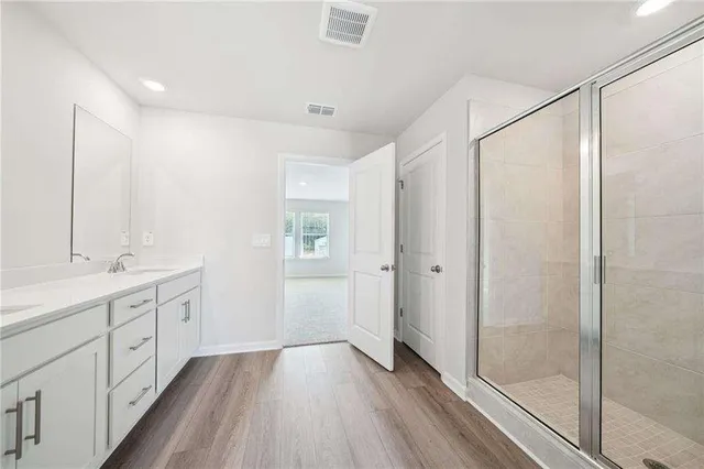 a bathroom with a double vanity sink and mirror